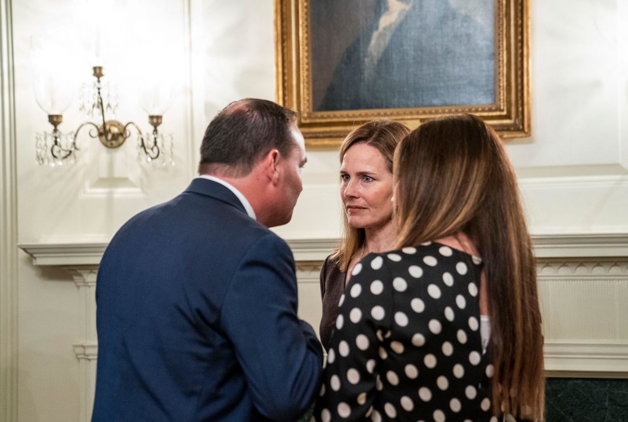 US Sen. Mike Lee and his wife, Sharon, chat with Barrett during <a href="https://www.cnn.com/2020/10/04/politics/gallery/barrett-announcement-inside-white-house-0926/index.html" target="_blank">a private reception inside the White House</a> after Barrett's nomination ceremony on September 26. Lee later tested positive for the coronavirus.