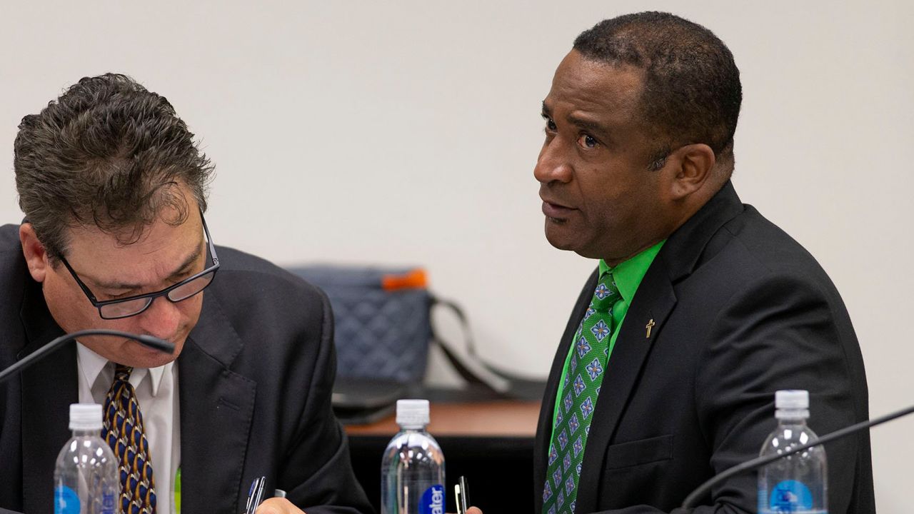 Former principal William Latson, right, and his attorney confer at a court hearing in West Palm Beach, Florida, on February 4.