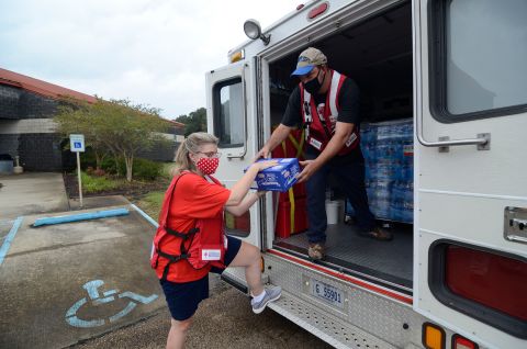 American Red Cross volunteers Cindy Romig and Cliff Boyer unload supplies outside the Pike County Community Safe Room storm shelter in Magnolia, Mississippi, on October 9.