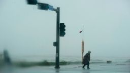 A man walks across the street as the outer bands of Hurricane Delta make landfall in Galveston, Texas on October 9, 2020. - Hurricane Delta churned toward the Louisiana coast on october 9 packing ferocious winds and potential for a dangerous storm surge and flooding -- prompting the evacuation of people still rebuilding from a devastating storm less than two months ago. (Photo by Mark Felix / AFP) (Photo by MARK FELIX/AFP /AFP via Getty Images)