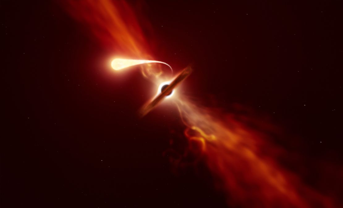 This illustration depicts a star (in the foreground) experiencing spaghettification as it's sucked in by a supermassive black hole (in the background) during a "tidal disruption event." 