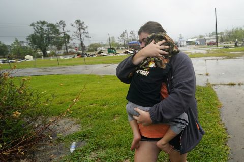 Danielle Fontenot runs to a relative's home in the rain with her son Hunter ahead of Hurricane Delta in Lake Charles, Louisiana, on October 9.