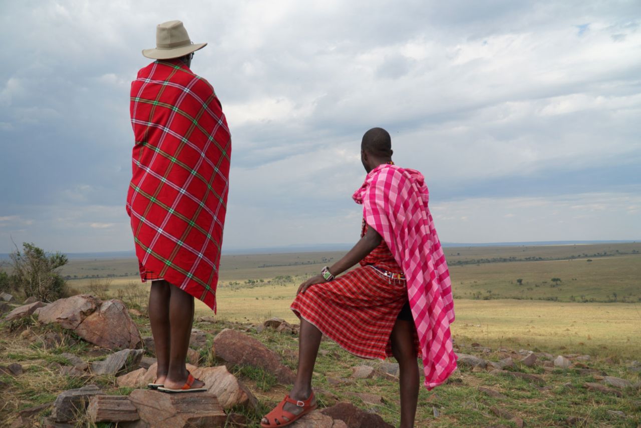 Two Maasai landowners look out on the Maasai Mara. Due to the pandemic this year, lease payments on their land halved as tourism to the Maasai Mara has slowed to a trickle.