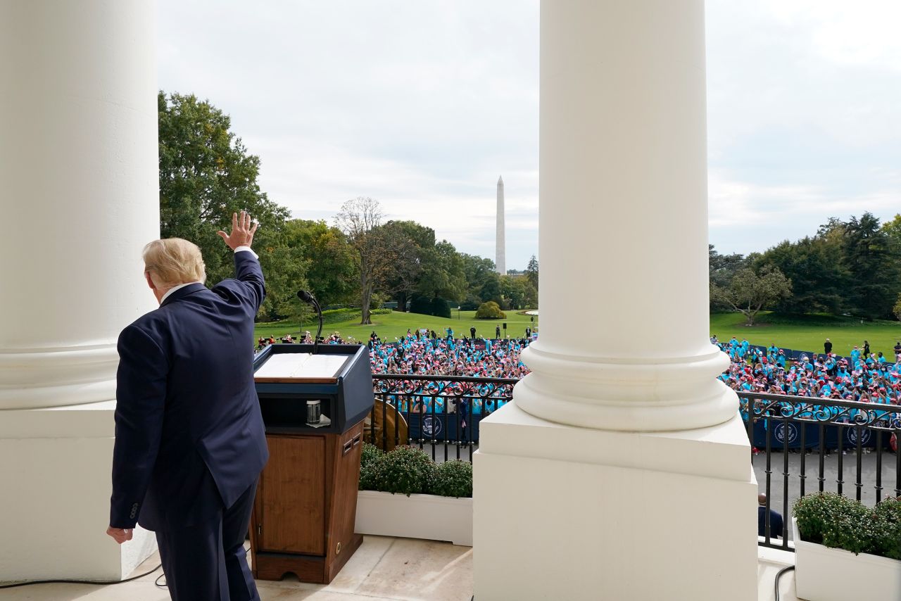 President Donald Trump waves to supporters from the balcony of the White House on Saturday. 