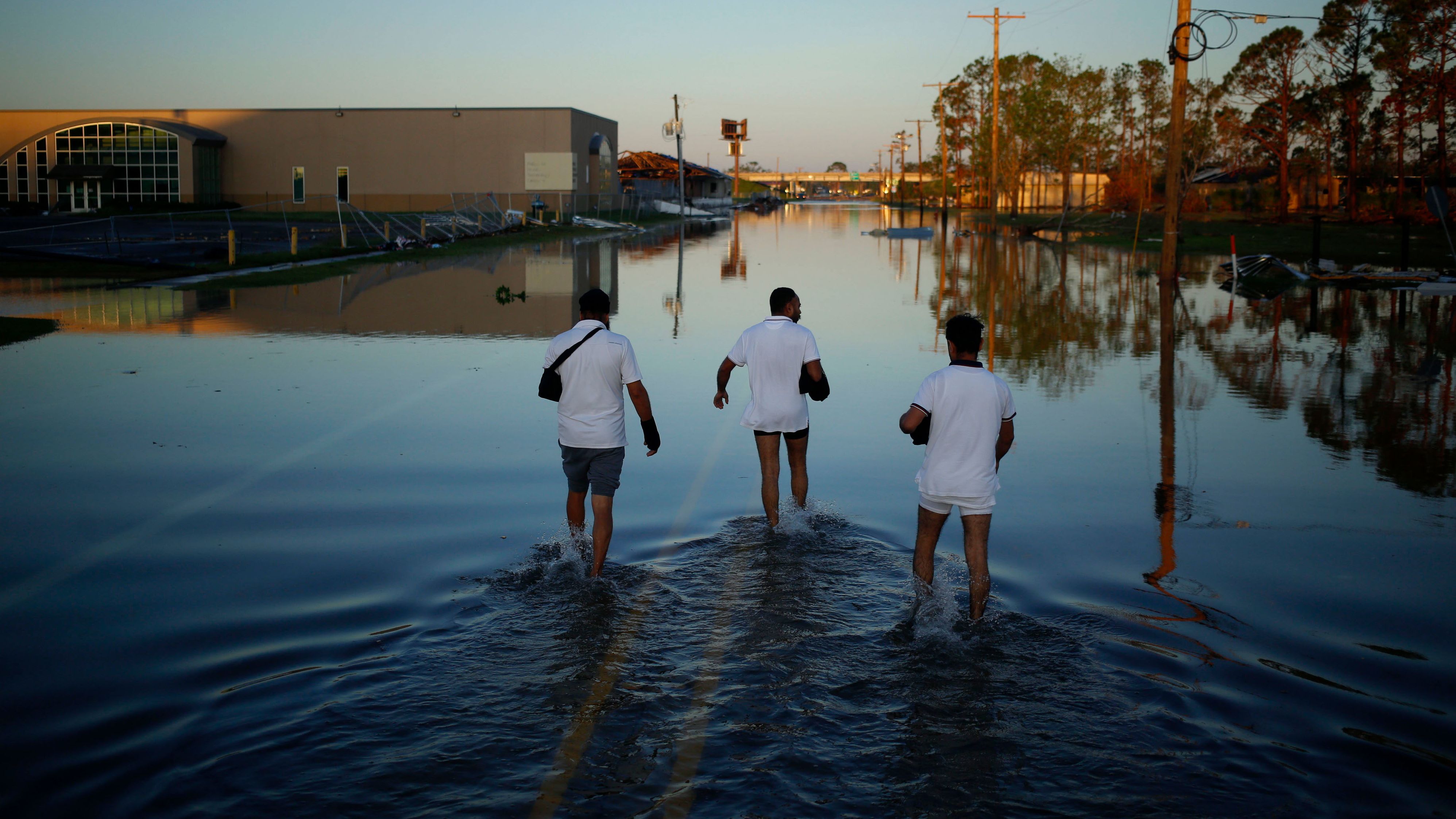 Residents walk through flooded streets in Lake Charles, Louisiana, on October 10.