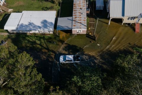 A vehicle drives through flood waters after Hurricane Delta made landfall in this aerial photograph taken above Delcambre, Louisiana, on Saturday, October 10. 