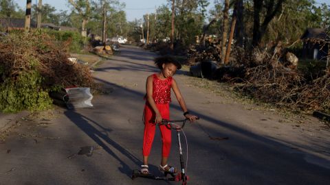 Iyana Sells, 9, plays on a debris-lined street Saturday after Hurricane Delta swept through Lake Charles.