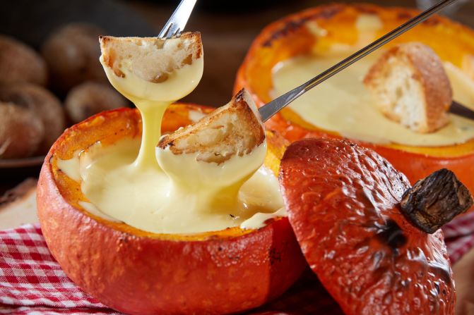Hollow out smaller gourds and fill with <a href="index.php?page=&url=https%3A%2F%2Fwww.foodandwine.com%2Frecipes%2Fclassic-swiss-cheese-fondue" target="_blank" target="_blank">cheese fondue</a> for individual treats for every family member. 