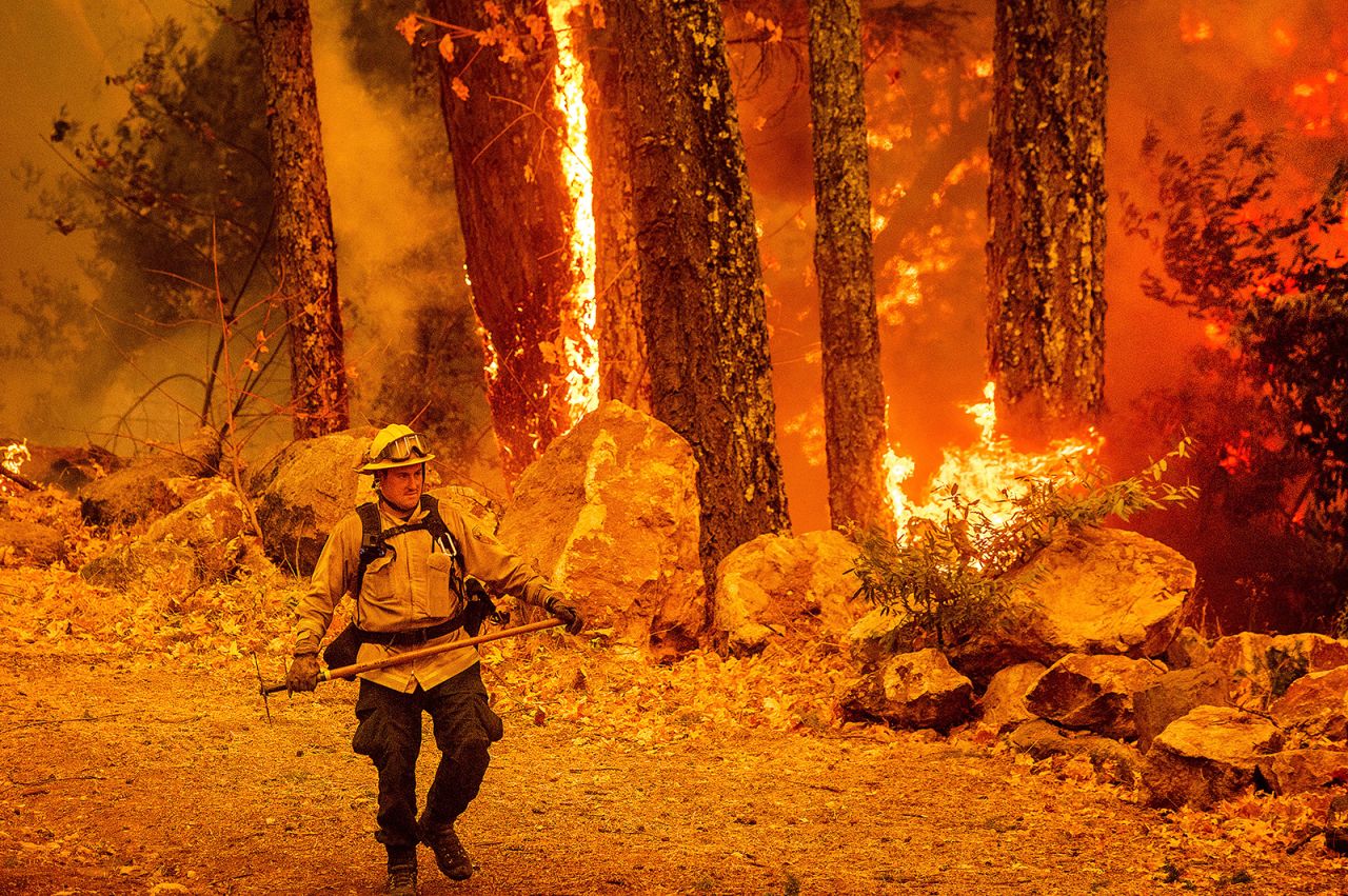 A firefighter walks along a path as the Glass Fire burns in Calistoga, California, on October 1, 2020.