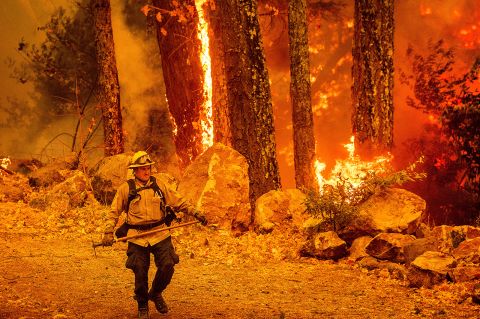 A firefighter walks along a path as the Glass Fire burns in Calistoga, California, on October 1.