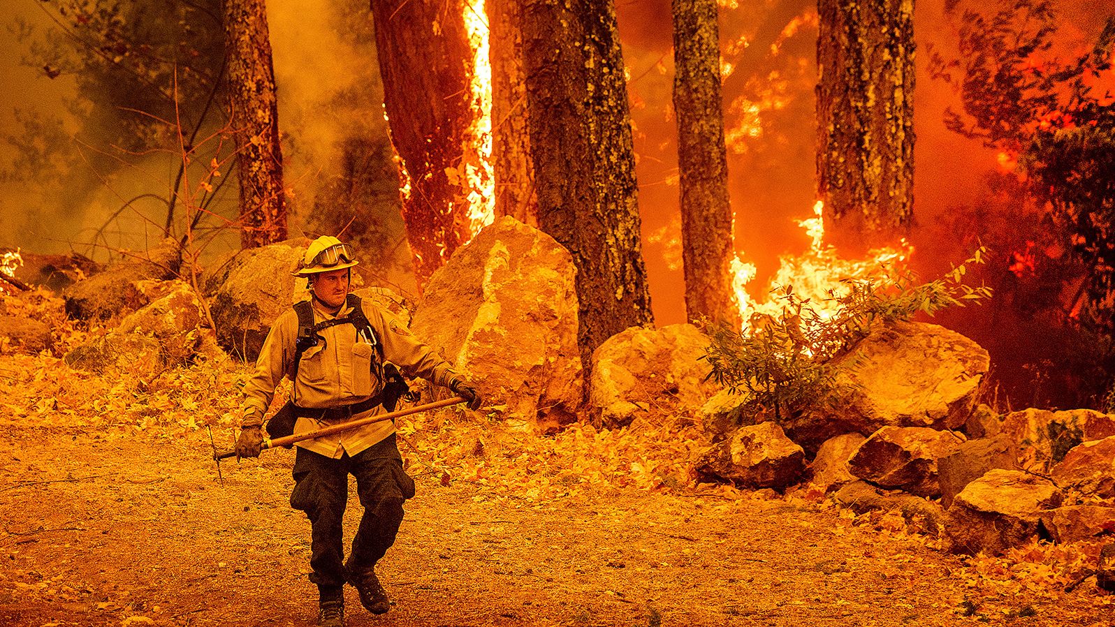 A firefighter walks along a path as the Glass Fire burns in Calistoga, California, on October 1, 2020.