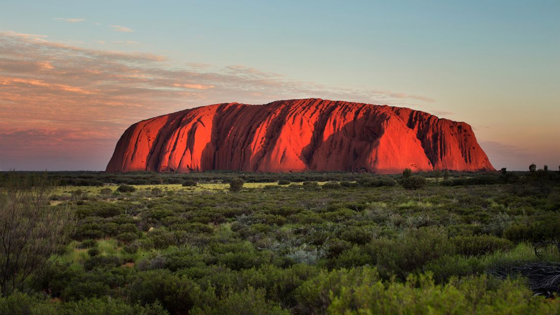 <strong>3. Uluru-Kata Tjuta National Park, Australia:</strong> The sandstone monolith of Uluru looks spectacular under a radiant and golden sunset, highlighting all its natural beauty.  
