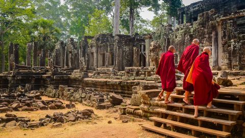 Buddhist monks enter the Bayon Temple at Angkor Wat, Siem Reap, Cambodia