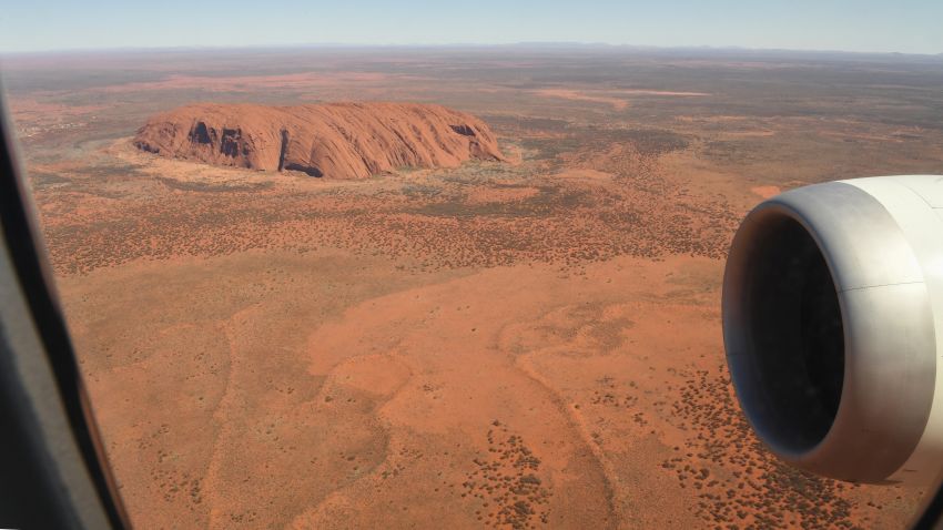 ULURU, AUSTRALIA - OCTOBER 10: Qantas flight number QF787, a Boeing 787 Dreamliner aircraft flies close to Uluru in the Uluru-Kata Tjuta National Park, Northern Territories on October 10, 2020 in Uluru, Australia. With international and domestic border closures due to the COVID-19 pandemic putting a halt on travel, the Qantas Great Southern Land Scenic flight will take 150 passengers on an aerial tour over iconic Australian destinations. The seven-hour scenic flight on board a Qantas 787 Dreamliner aircraft - usually used for long haul international flights - will perform a loop from Sydney up to locations along the New South Wales and Queensland coasts as well as Uluru in the Northern Territory before landing back in Sydney. (Photo by James D. Morgan/Getty Images)