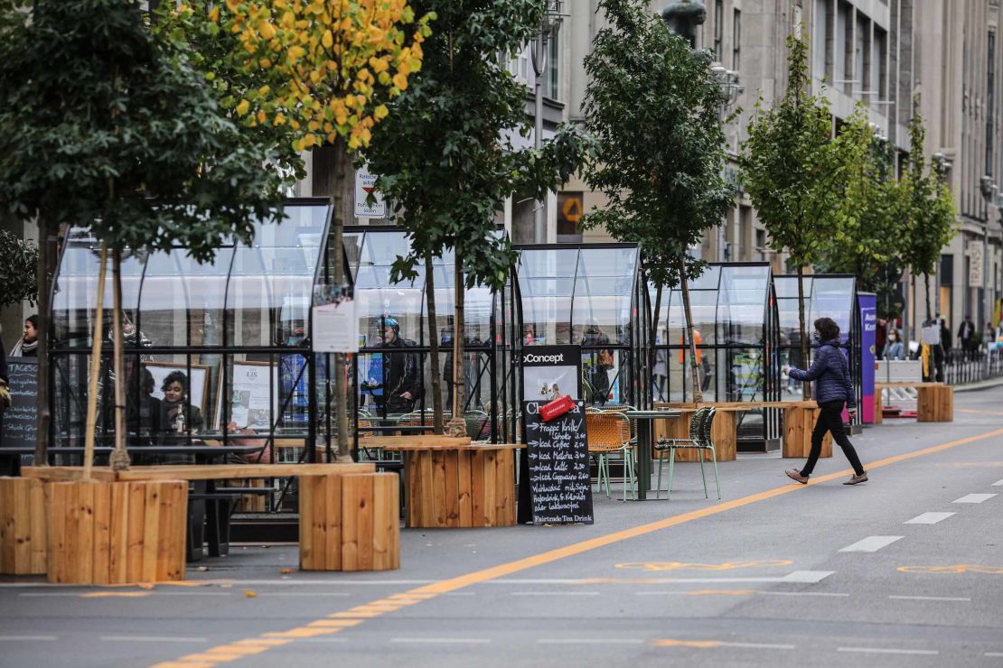 Mostly empty seating areas outside a coffee shop at Friedrichstraße in Berlin on Friday, with the city facing new rules.