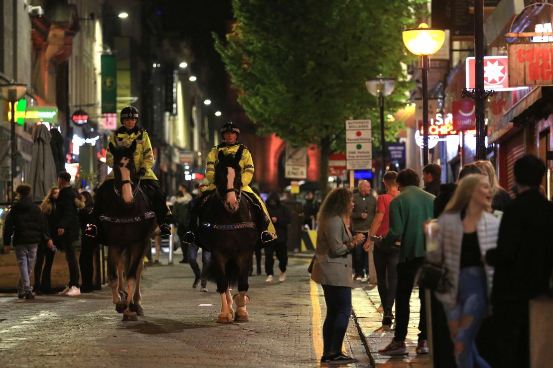 Police patrol as revelers enjoy a night out in the center of Liverpool, northwest England on Saturday, ahead of strict new measures planned in the area.