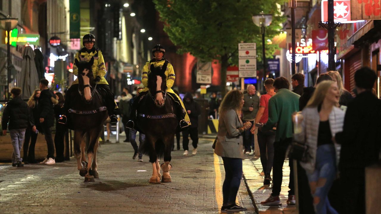 Police patrol as revelers enjoy a night out in the center of Liverpool, northwest England on Saturday, ahead of strict new measures planned in the area.