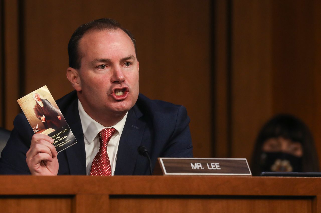 US Sen. Mike Lee, a Republican from Utah, holds up a copy of the US Constitution while speaking on October 12. Lee<a href="https://www.cnn.com/2020/10/03/politics/trump-covid-amy-coney-barrett-event/index.html" target="_blank"> tested positive for the coronavirus</a> shortly after attending Barrett's nomination ceremony on September 26. He has been cleared by his physician to attend the hearings, he said.