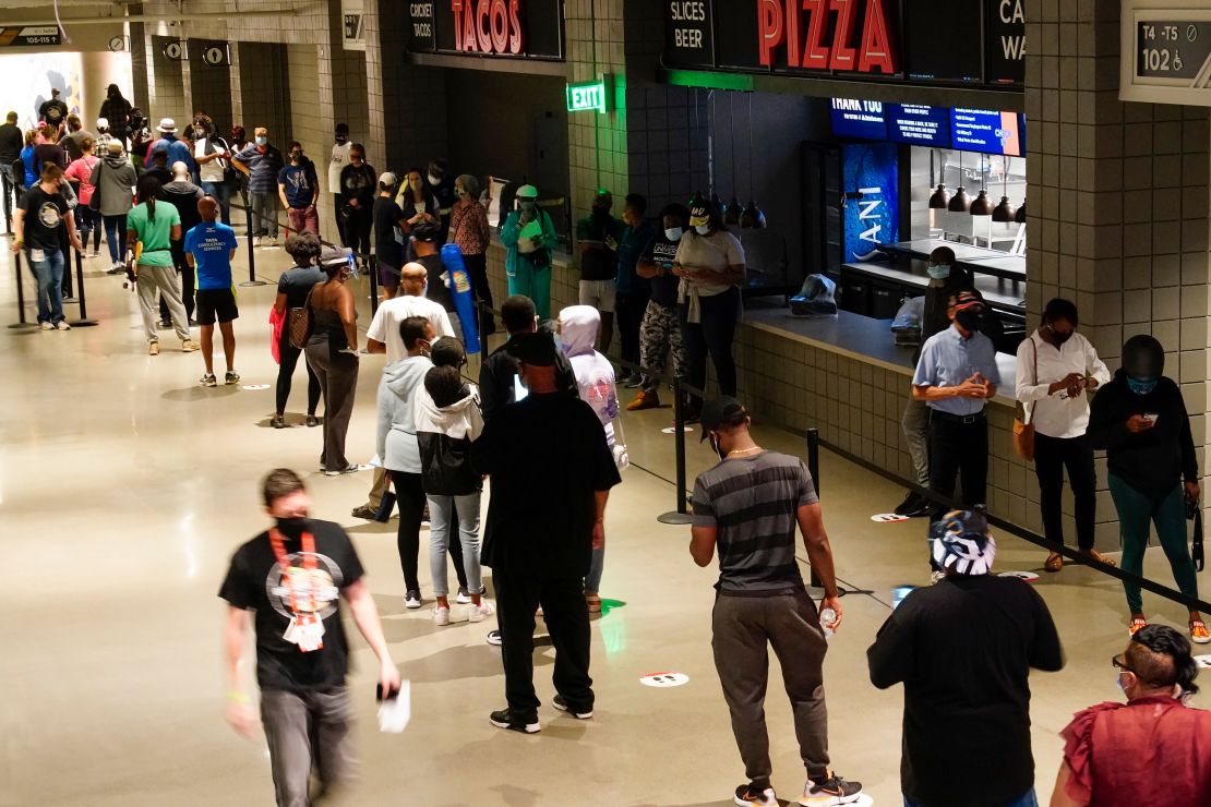 Long lines have greeted voters at many early polling locations. Here people wait in line to vote at State Farm Arena in Atlanta on Monday.