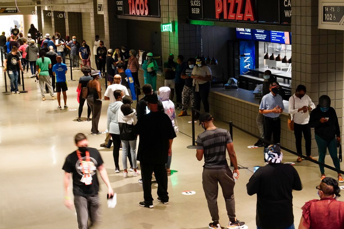 Long lines have greeted voters at many early polling locations. Here people wait in line to vote at State Farm Arena in Atlanta on Monday. 