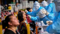 A health worker takes a swab from a resident to be tested for the COVID-19 coronavirus in Qingdao, in China's eastern Shandong province on October 12, 2020. (Photo by STR / AFP) / China OUT (Photo by STR/AFP via Getty Images)