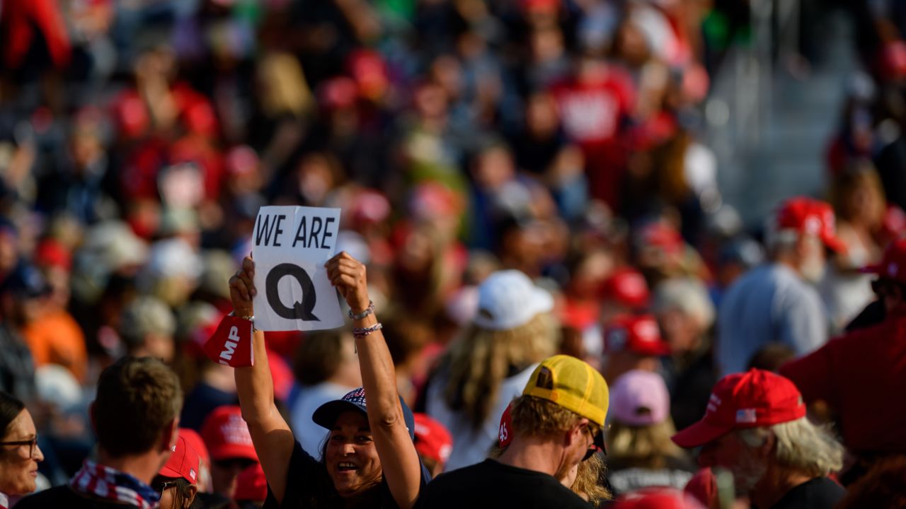 A woman holds up a QAnon sign at a President Trump campaign rally on September 22, 2020, in Moon Township, Pennsylvania. 