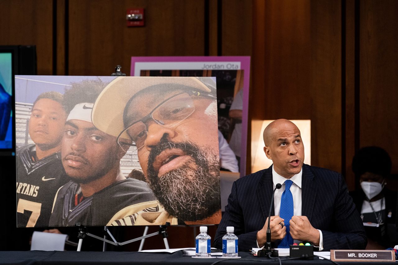 US Sen. Cory Booker, a Democrat from New Jersey, speaks during the first day of the hearings. Behind him were photographs of people who would be impacted by the elimination of the Affordable Care Act.