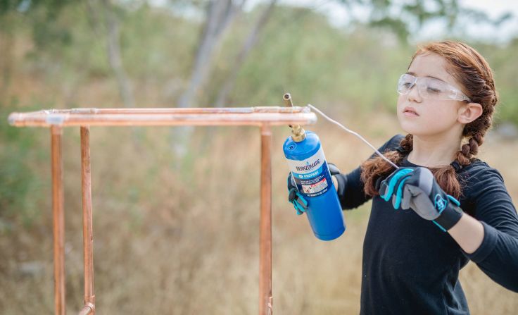 <strong>Sofia, 9,</strong> shown here making a copper stool, said building makes her feel "proud of myself."