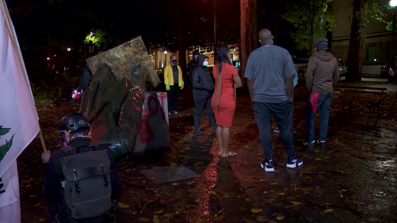 People gathered around the Abraham Lincoln statue, which was pulled down on Sunday night.