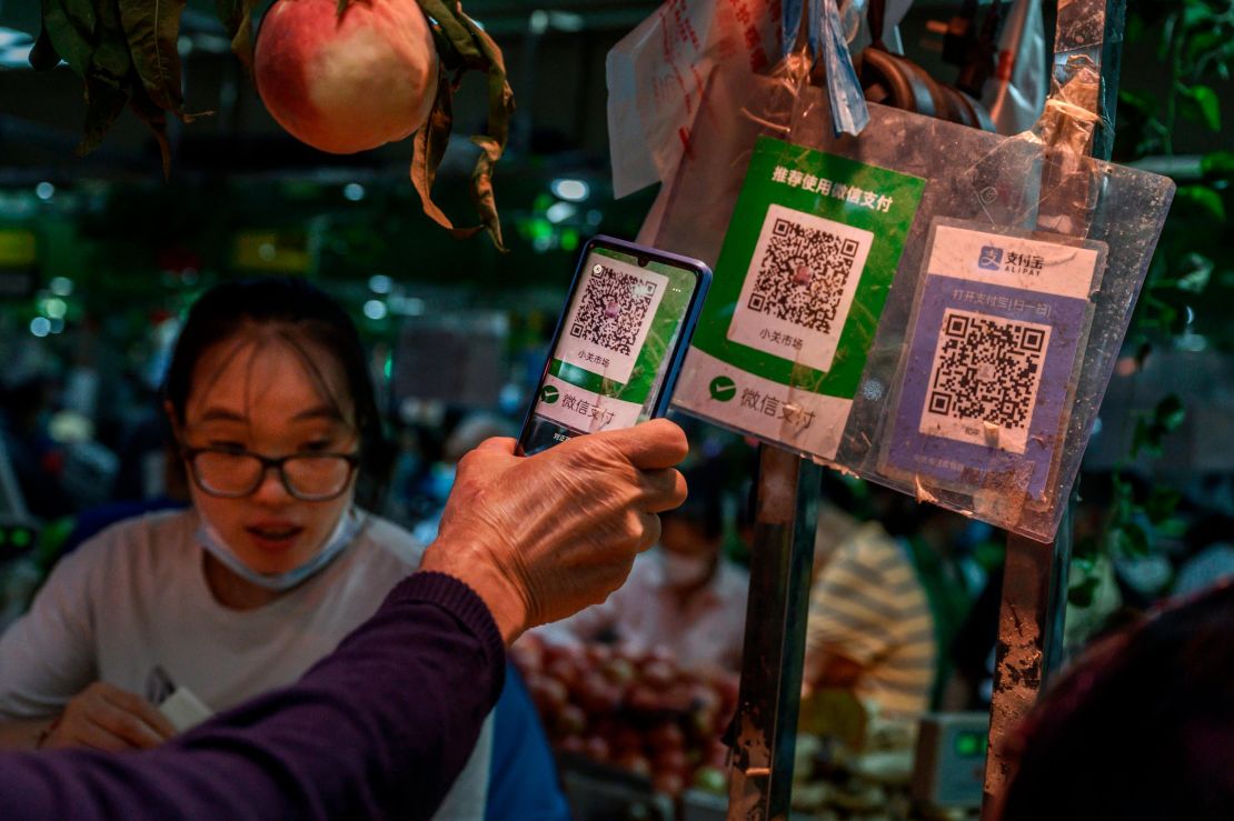 A Chinese customer using his phone to pay via a QR code with the WeChat app at a market in September in Beijing.