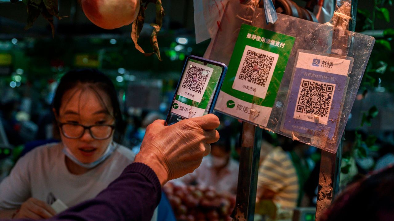 A Chinese customer using his phone to pay via a QR code with the WeChat app at a market in September in Beijing.
