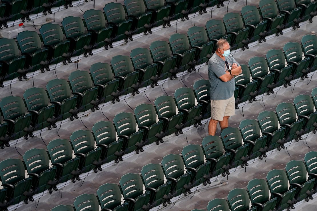 A fan watches batting practice and player warmups from the stands prior to Game 1 of the NLCS between the Braves and the Dodgers.