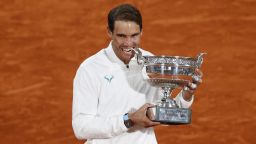 PARIS, FRANCE - OCTOBER 11: Rafael Nadal of Spain bites the winners trophy following victory in his Men's Singles Final against Novak Djokovic of Serbia on day fifteen of the 2020 French Open at Roland Garros on October 11, 2020 in Paris, France. (Photo by Clive Brunskill/Getty Images)