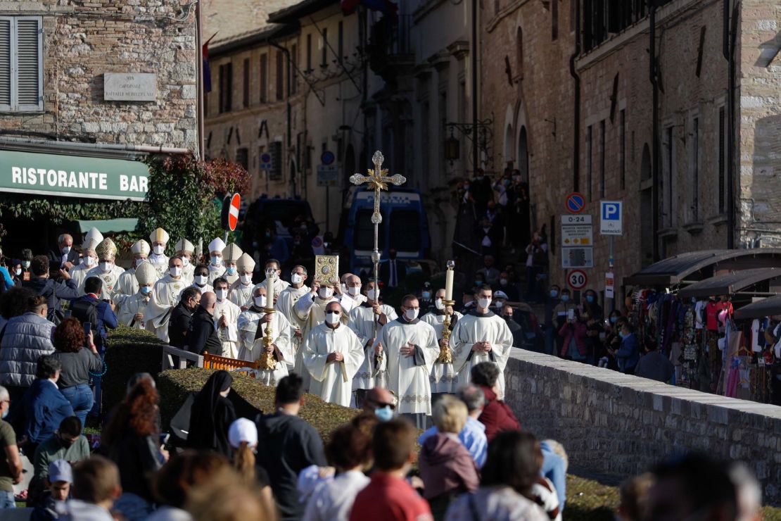 A procession walks through the streets of Assisi, Italy, prior to the beatification ceremony of 15-year-old Carlo Acutis.