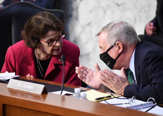 Democratic Sens. Feinstein and Dick Durbin speak to each other during Barrett's testimony on October 13.