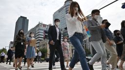 People wearing face masks cross a road in Seoul on September 11, 2020. - South Korea largely overcame an early COVID-19 coronavirus outbreak with extensive tracing and testing, but is now battling several outbreaks. (Photo by Jung Yeon-je / AFP) (Photo by JUNG YEON-JE/AFP via Getty Images)