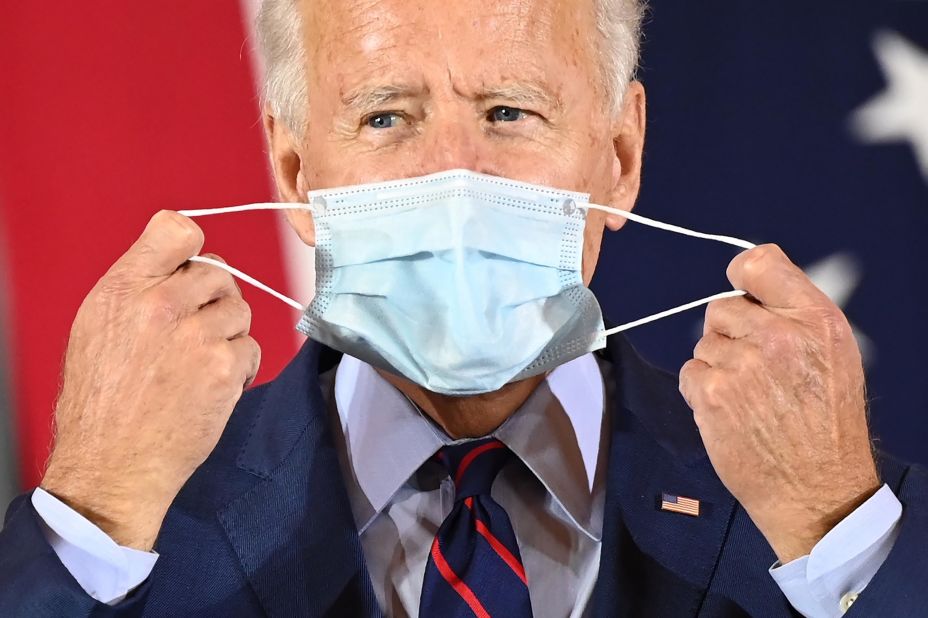 Biden puts on a face mask as he delivers remarks at a voter mobilization event in Cincinnati on October 12.