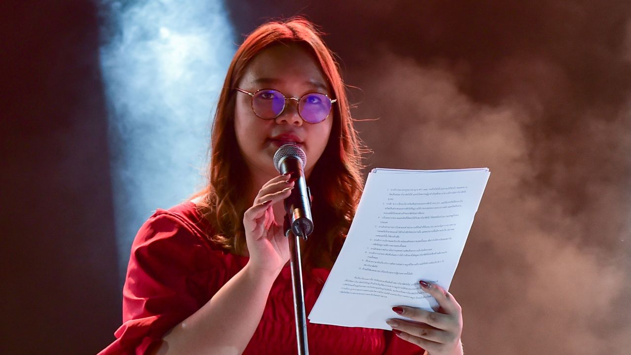 Panusaya Sithijirawattanakul reads a list of demands during a pro-democracy rally at Thammasat University on August 10.