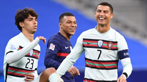 Ronaldo (right) shares a joke with French striker Kylian Mbappe (center) during Portugal's Nations League match.