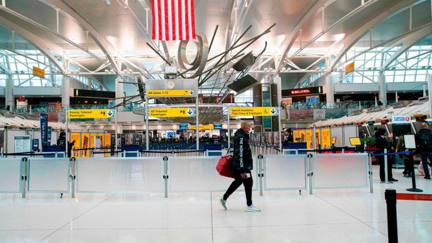 A man walks past counters at the Terminal 1 section at John F. Kennedy International Airport on March 12, 2020 in New York City. - US President Donald Trump announced a shock 30-day ban on travel from mainland Europe over the coronavirus pandemic that has sparked unprecedented lockdowns, widespread panic and another financial market meltdown Thursday.The announcement came as China, where the outbreak that first emerged in December, showed a dramatic drop in new cases and claimed "the peak" of the epidemic had passed. (Photo by Kena Betancur / AFP) (Photo by KENA BETANCUR/AFP via Getty Images)