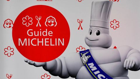 A man holds a glass of wine during the presentation of Germany's Michelin Guide 2017 in Berlin on December 1, 2016. (Photo by TOBIAS SCHWARZ / AFP) (Photo by TOBIAS SCHWARZ/AFP via Getty Images)