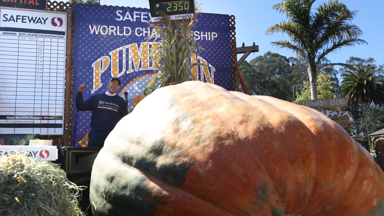 Travis Gienger pumps his fist as he stands next to his pumpkin during the competition in California.