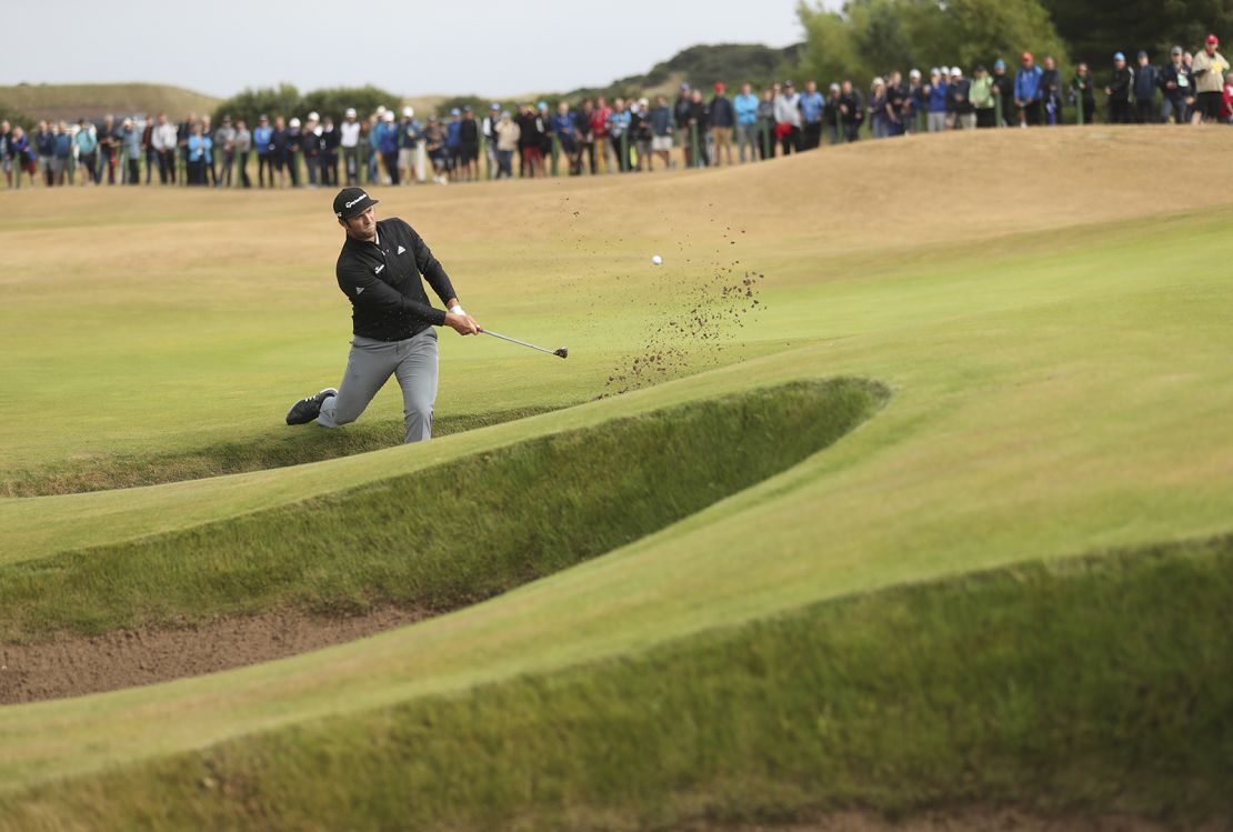 Rahm plays out of a bunker during the second round of The Open in Carnoustie, Scotland.