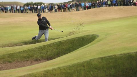 Rahm plays out of a bunker during the second round of The Open in Carnoustie, Scotland.