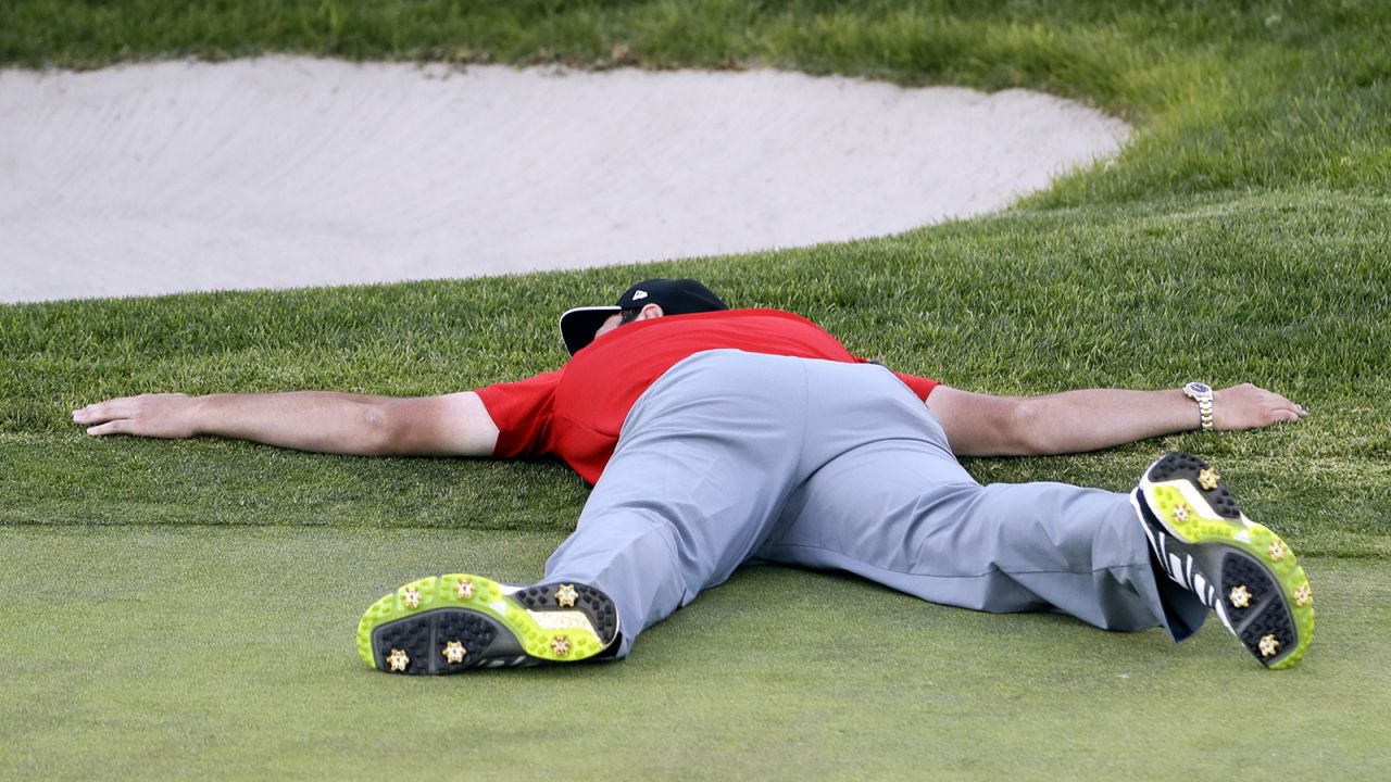 Rahm lies on the green of the 18th hole after winning the Farmers Insurance Open in 2017.