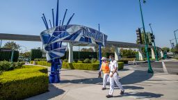 ANAHEIM, CA - SEPTEMBER 30: Employees walk past the entrance to Disneyland Park on Wednesday, Sept. 30, 2020 in Anaheim, CA. After suffering losses for months due to Gov. Newsoms mandatory coronavirus shut-down, Disney says it will lay off 28,000 employees across its parks, experiences and consumer products segment.(Allen J. Schaben / Los Angeles Times via Getty Images)