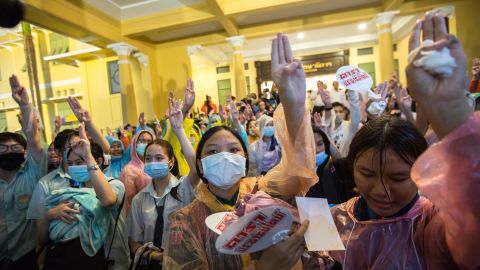 High school students raise their hands showing the three-finger sign during a protest in front of the Ministry of Education building in Bangkok on October 2.