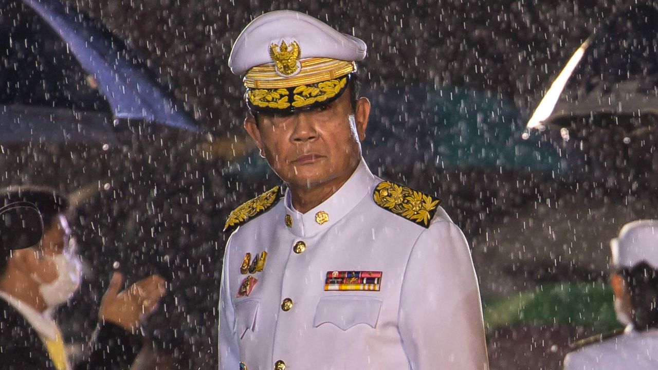 Prime Minister Prayut Chan-o-cha is seen amidst a heavy downpour during an event marking the death of late Thai King Bhumibol Adulyadej on October 13.