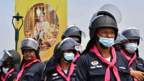 A portrait of Thailand's King Maha Vajiralongkorn is seen as police monitor an anti-government rally by pro-democracy protesters in Bangkok on October 14.