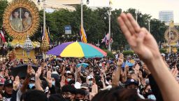 Pro-democracy protesters give the three-finger salute as they march towards Government House during an anti-government rally in Bangkok on October 14, 2020. (Photo by Jack TAYLOR / AFP) (Photo by JACK TAYLOR/AFP via Getty Images)